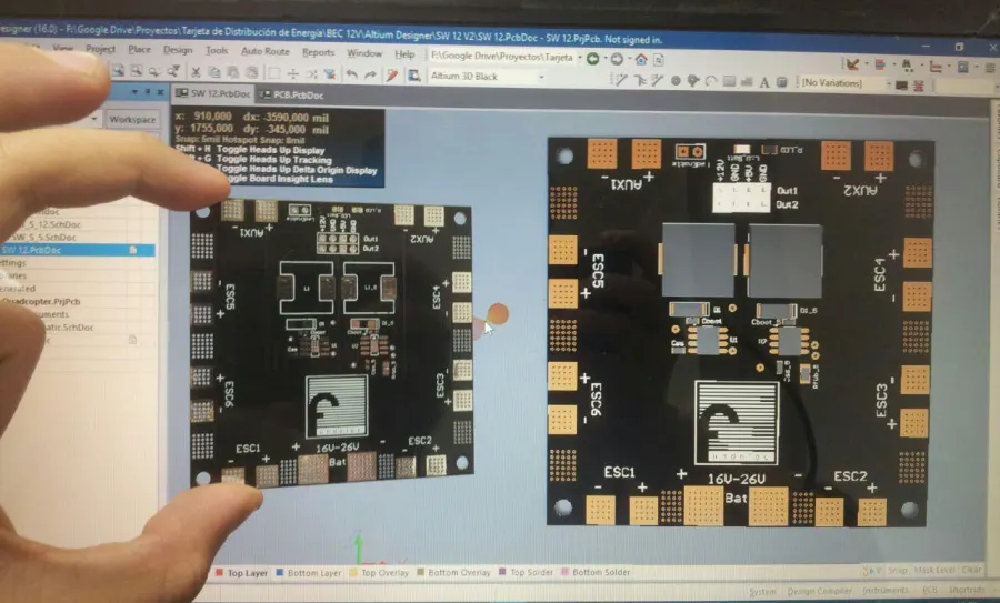 Fabricated power distribution board held up in front of its Altium 3D view